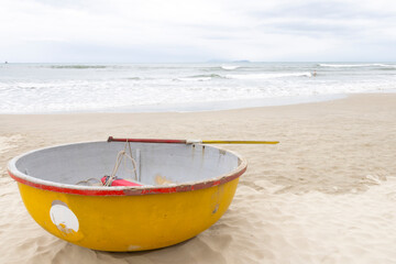 Fototapeta na wymiar Coconut basket boat on My Khe Beach in Danang, Vietnam