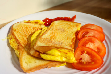 Simple breakfast menu, bread toast with egg and tomato