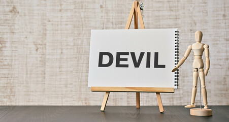 There is notebook with the word DEVIL. It is as an eye-catching image.