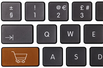 Internet store. Brown button with shopping cart on computer keyboard, top view
