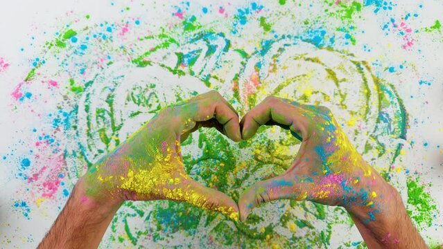 Hands Of A Man Making Heart For Holi Festival