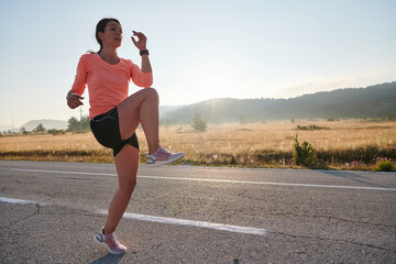 Determined Stretch: Athletic Woman Embraces Post-Run Flexibility in Nature.