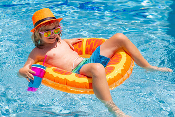 Child play in pool in summer day. Children playing in swimming pool. Summer holidays and vacation concept.