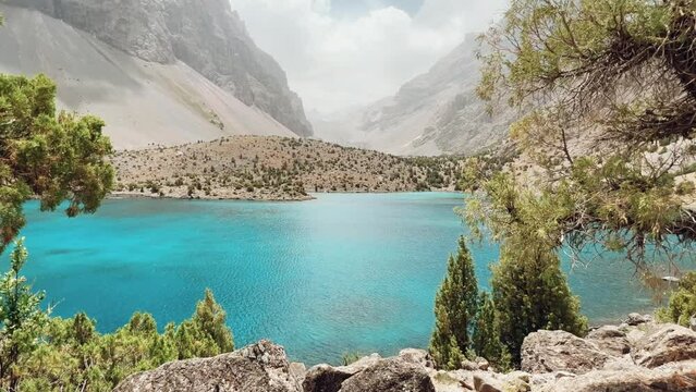 The Alaudin (Chapdara) lakes, lying at an altitude of 2800 m, are considered one of the most beautiful lakes of the Fan Mountains. Turquoise mountain lake. Pamiro-Alai. Tajikistan, Pamir 4K