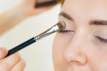 Makeup artist applying eye make up