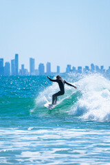 Male surfer riding a wave like a pro in Gold Coast, Queensland, Australia