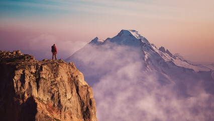 Adventurous Man Hiker on peak. Snowy mountain view. Adventure Composite.