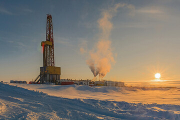 Drilling a deep well for oil and gas production in a northern field. Winter polar day. The low sun...