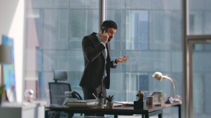Furious business owner calling shouting at office. Angry manager phone talking