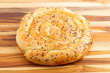 Vertuta Pie of Phyllo Pastry Filled with Feta Cheese and Sprinkled with Toasted Sesame Seeds .