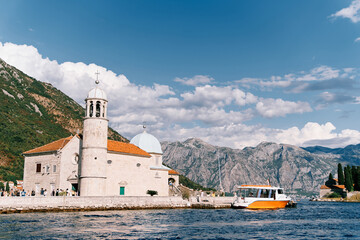 Excursion boats are moored at the island of Gospa od Skrpjela. Montenegro