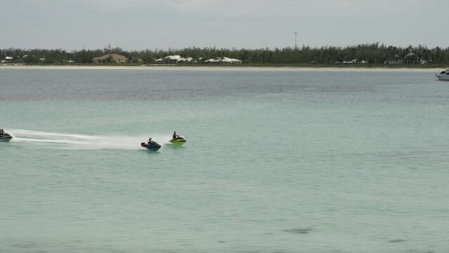 Epic jet skis speeding across Bahamas ocean - circling drone shot
