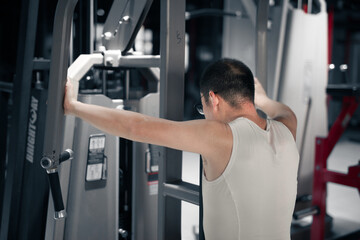 Fototapeta na wymiar The men's gym exercises their arm muscles