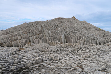 texture of porous stones on the beach, nature, natural phenomena, grey stones, columnar stones