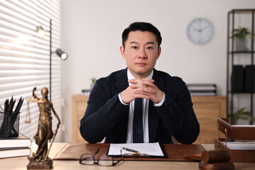 Notary working at wooden table in office