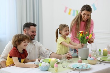 Obraz na płótnie Canvas Easter celebration. Happy family setting table at home
