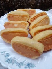 Kue pukis. A half-moon-shaped cake made from a mixture of flour, coconut milk and eggs. Pukis cake was soft and sweet. Snack from Indonesia.