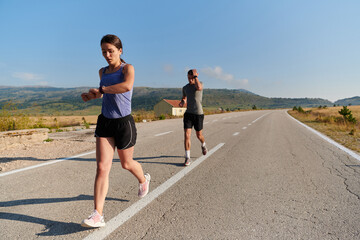 Energized by the beauty of nature, a couple powers through their morning run, their bodies and...