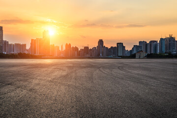  Asphalt road square and city skyline with modern buildings scenery at sunset