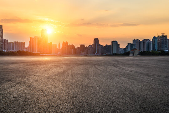  Asphalt road square and city skyline with modern buildings scenery at sunset © ABCDstock