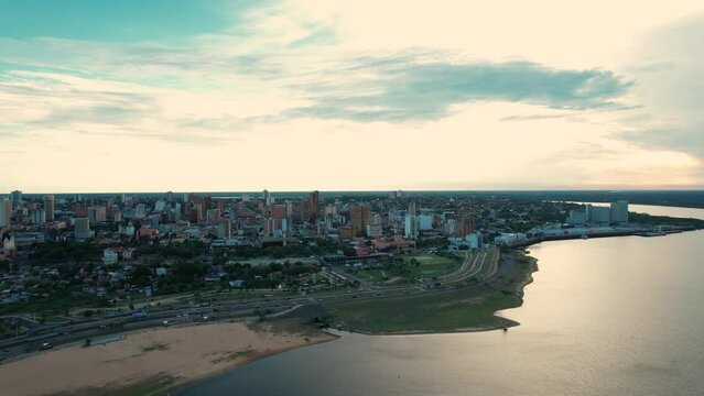 Explore the vibrant city of Asunci&oacute;n from above, with its meandering rivers and sunny coastline. A stunning landscape to inspire your creative projects