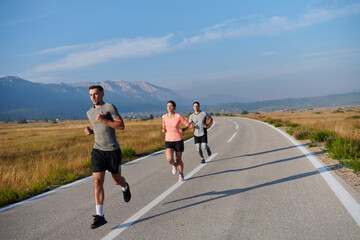A group of friends maintains a healthy lifestyle by running outdoors on a sunny day, bonding over fitness and enjoying the energizing effects of exercise and nature