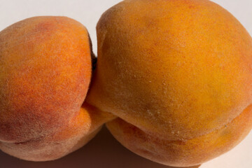 Two glued peach fruits. Siamese twins. A fruit anomaly.