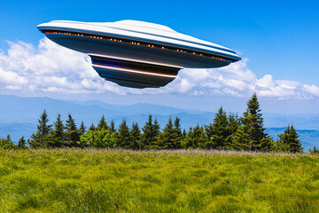UFO coming in at an angle for a landing in a mountain meadow on a beautiful day in the Southern Appalachian Mountains. - 757659161