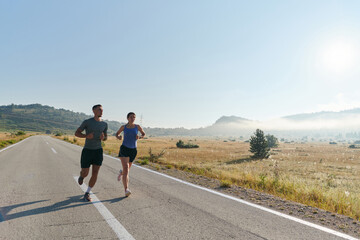 Energized by the beauty of nature, a couple powers through their morning run, their bodies and spirits invigorated.