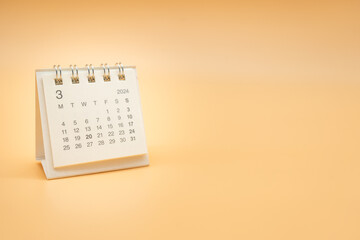 Simple desk calendar for MARCH 2024 isolated on orange background. Calendar concept with copy space.