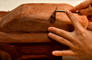 Designers work on the car's sculpture using carving tools. Adjust the surface of the model. in the automotive industry