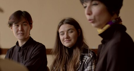 Personal coaching or life coaching process. Portrait of young people talking with trained coach, listen carefully, set personal or professional goals. Students meeting with professional coach indoor. 