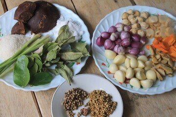 Various kinds of Indonesian cooking spices in plates on the table