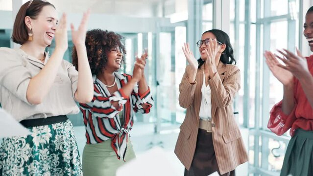 Women, celebration and throw paper in office for success, target or achievement at startup company. Group, team work and confetti for goal with cheers, support and diversity at creative media agency