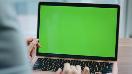 Unknown girl using chroma key laptop for office work closeup. Hands scrolling pc