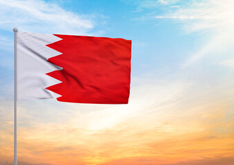3D illustration of a Bahrain flag extended on a flagpole and in the background a beautiful sky with a sunset