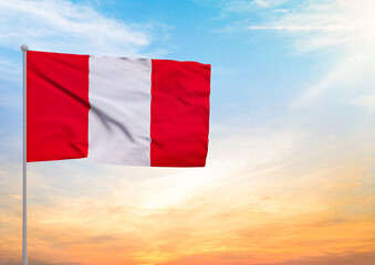 3D illustration of a Peru flag extended on a flagpole and in the background a beautiful sky with a sunset