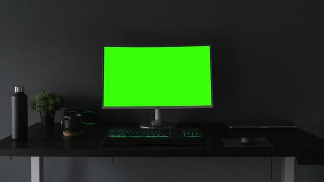 Computer desktop with mock-up green screen white background in office, Zoom shoulder view.