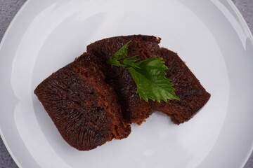 overhead shot of chocolate caramel cake with mint on a plate