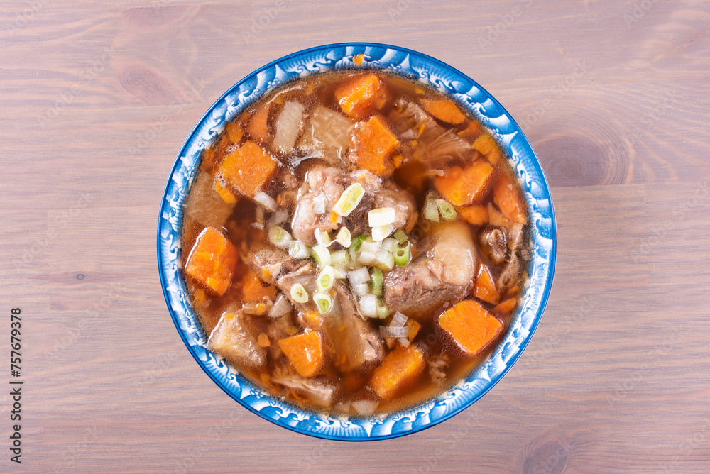 Wall mural Braised beef brisket, radish and carrot on the table