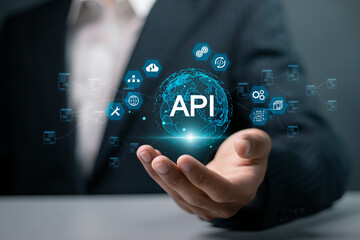 API, Application programing interface concept, software development tool, information technology. Businessman holding globe and API icon on virtual screen. - obrazy, fototapety, plakaty