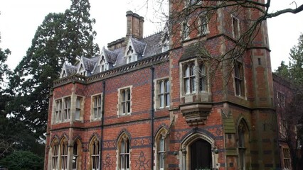 A victorian manor house hotel in the country with gothic architecture and spooky windows