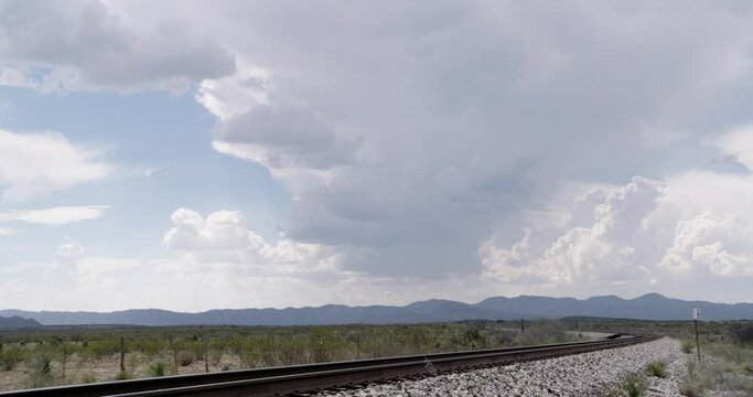 Trains tracks surrounded by endless clouds and skies, West Texas