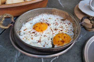 double Fried eggs in a cooking pan close up ,
