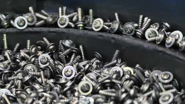 Close up scene the automatic screw feeder with vibration.