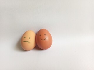 Brown eggs with face expression of sad and happy