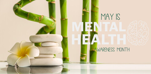 Stack of spa stones, flower and bamboo on light background