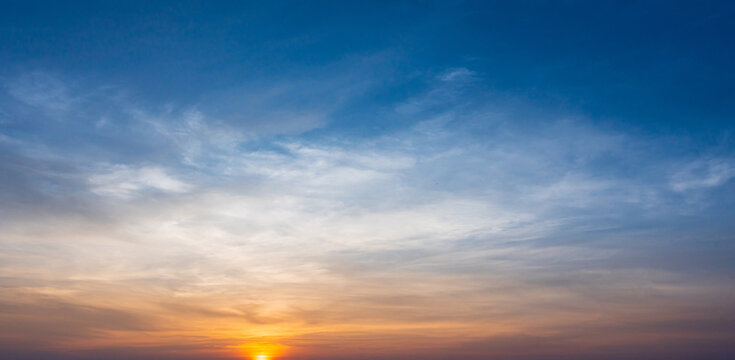 Dramatic cloudy sky and bright sunrise or sunset over the horizon. Natural skyscape background
