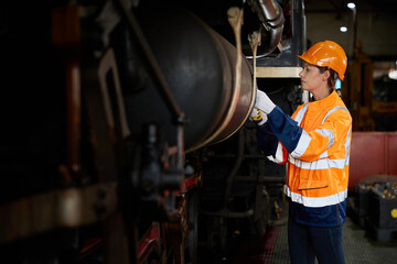 engineer or technician checking construction train at station