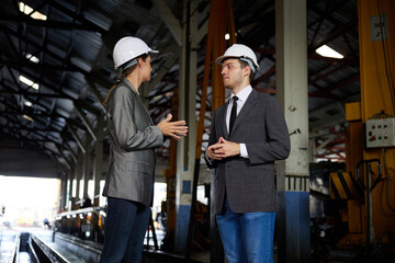 businesspeople or architect meeting and talking at construction site